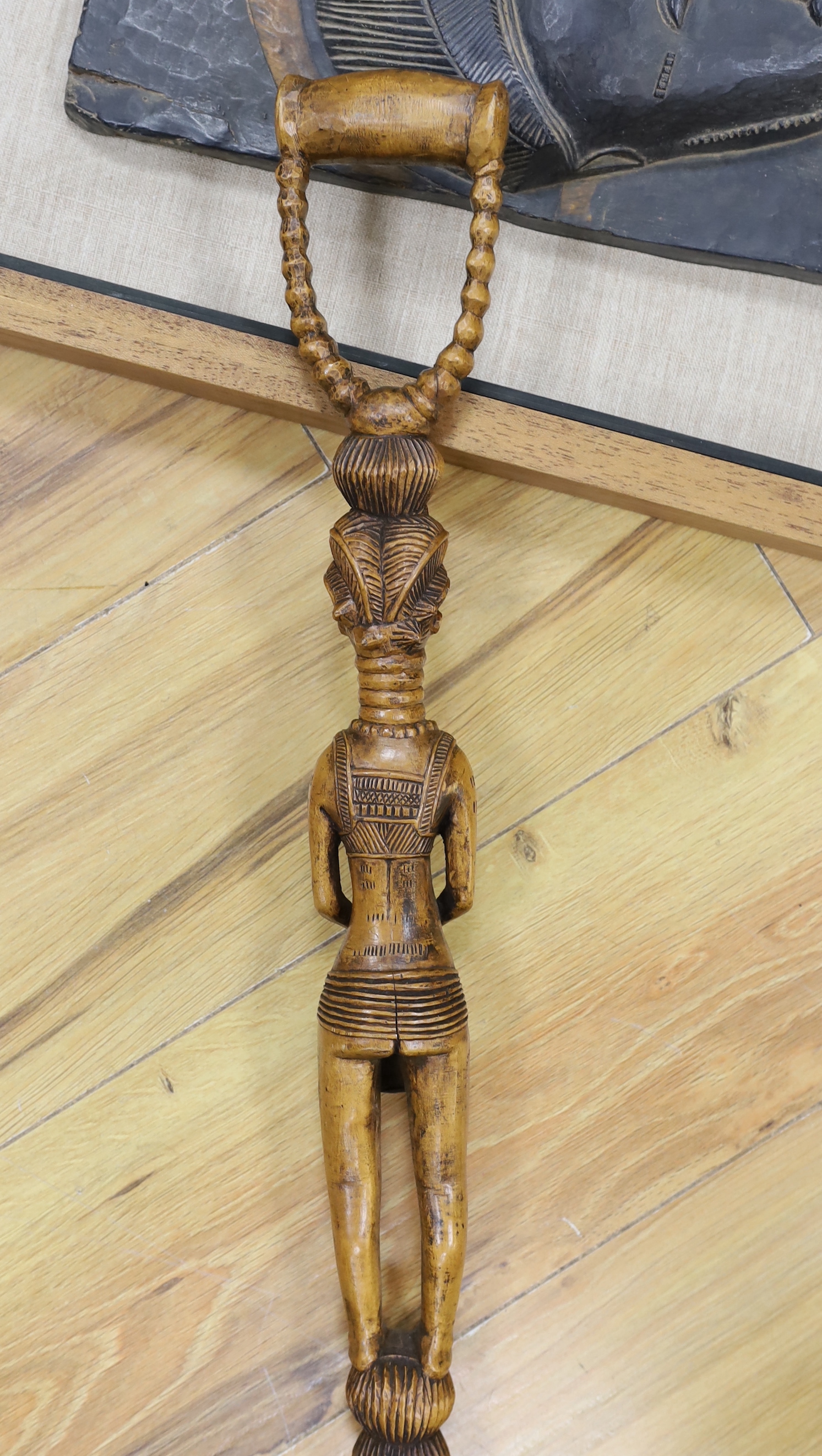 An African framed tribal mask and a carved stick